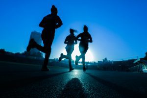 Photo of people jogging at dawn